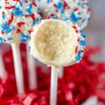 Bite into a white chocolate-covered 4th of July cake pop with red, white, and blue sprinkles.
