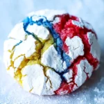 Red, white, and blue crinkle cookie with powdered sugar coating on white parchment paper