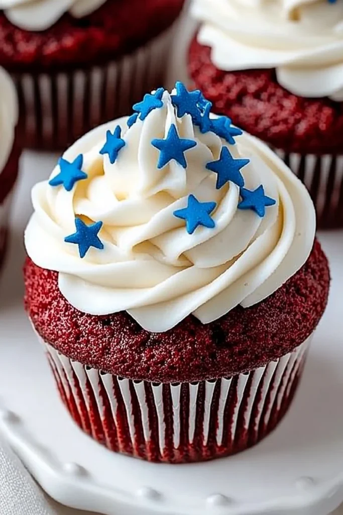Red Velvet Cupcakes With Cream Cheese Frosting for 4th of July 7 Close Up of Red Velvet Cupcake with Cream Cheese Frosting and Blue Star Sprinkles