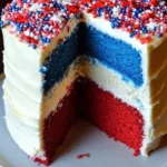 Red White and Blue Cheesecake Cake: A Festive Summer Holiday Delight 9 Layered blue cake, white cheesecake, and red cake slice with creamy white frosting and festive patriotic sprinkles on a rustic ceramic plate