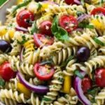Lemon Herb Mediterranean Pasta Salad – Fresh & Easy Dinner Recipe 5 Close-up of a colorful lemon herb Mediterranean pasta salad with rotini pasta, cherry tomatoes, kalamata olives, red onions, yellow bell peppers, and fresh basil in a rustic ceramic bowl