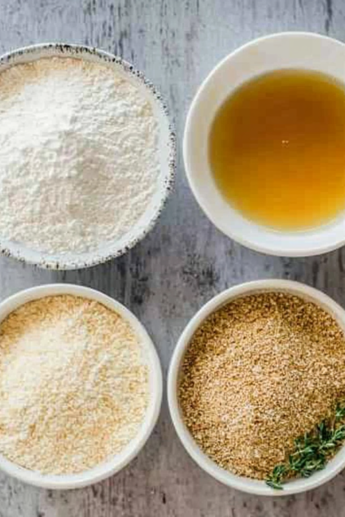 Crispy Pan Fried Zucchini: Easy Summer Veggie Delight 7 Breading station with bowls of flour, egg wash, and seasoned breadcrumbs for coating crispy pan fried zucchini.