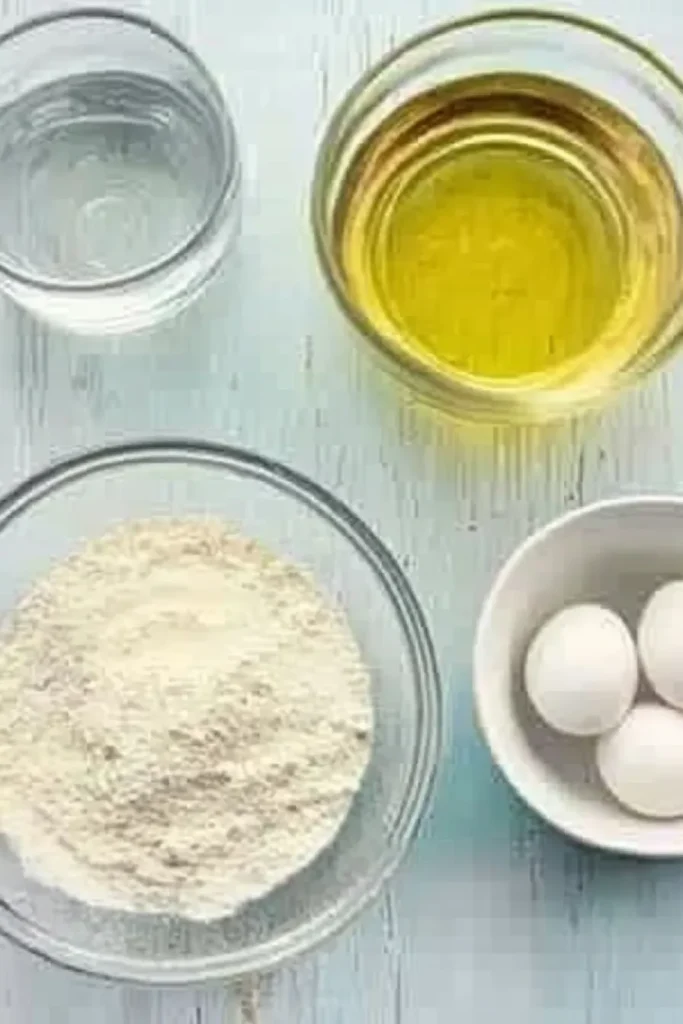 Patriotic Poke Cake: The Ultimate 4th of July Dessert 8 Measured ingredients for Patriotic Poke Cake including white cake mix, water, oil, and egg whites in bowls