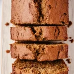 Best Ever Moist Zucchini Bread Recipe: Easy, Flavorful & Perfect for Summer 7 Close-up of moist homemade zucchini bread loaf with crispy cracked golden crust and tender crumb, sliced and served on a cream ceramic plate