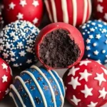 Patriotic Oreo Balls Recipe coated in red and blue candy melts with star sprinkles and white chocolate drizzle.