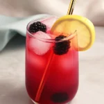 Blackberry Lemonade Recipe: Easy 4-Ingredient Summer Drink 7 Glass of homemade blackberry lemonade with ice, lemon slice, and blackberries on a summer table