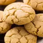 Pumpkin Sugar Cookies – Chewy, Spiced, and Easy to Bake 6 Chewy pumpkin sugar cookies with cracked golden tops, coated in sugar, resting on a cozy linen cloth for a rustic fall dessert look.