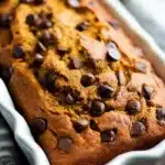 Chocolate Chip Pumpkin Bread – Amazing Fall Favorite Recipe 12 Moist chocolate chip pumpkin bread with melted chips in a ceramic loaf pan
