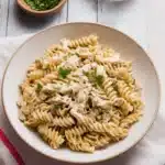 Crockpot Garlic Parmesan Chicken Pasta – A Remarkable Comfort Classic 6 Crockpot Garlic Parmesan Chicken Pasta served in a white bowl with rotini, shredded chicken, creamy garlic parmesan sauce, and fresh parsley garnish