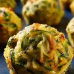 Zucchini Garlic Bites: Crispy, Cheesy & Perfect for Summer Snacks 7 Crispy zucchini garlic bite with golden crust and fresh herbs on a baking tray