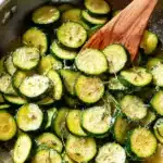 Easy sautéed zucchini cooked in a skillet with garlic, olive oil, and Parmesan, served warm and tender