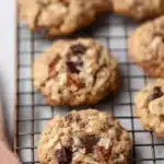 Cowboy Cookies Recipe: Chewy, Chunky, and Packed with Flavor 8 Chewy cowboy cookies with chocolate chunks, pecans, and coconut cooling on a wire rack.
