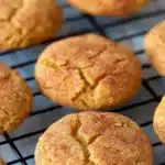 Soft pumpkin snickerdoodle cookies with cinnamon sugar coating on a cooling rack