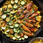 Garlic Butter Chicken with Zucchini and Corn – A Simple, Delicious Weeknight Win 9 Garlic butter chicken with zucchini and corn in a cast iron skillet, served with fresh herbs on a dark rustic background