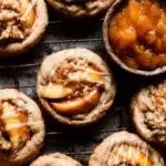 Peach Cobbler Cookies – Chewy, Fruity, and Crumb-Topped Delight 7 Chewy peach cobbler cookies with peach filling and crumble topping on a cooling rack with fresh peaches and glaze drizzle