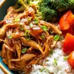 Crock Pot Teriyaki Chicken Recipe – Sweet, Tender & Easy 9 Shredded teriyaki chicken with vegetables and rice in a ceramic bowl topped with green onions
