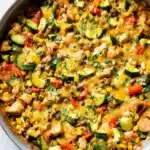 Chicken and Zucchini Recipe: Easy One-Pan Dinner Idea 12 Chicken and zucchini recipe cooked in one skillet with Tex-Mex veggies, melted cheese, and cilantro garnish