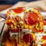 Zucchini Pizza Casserole: A Delicious Low-Carb Summer Favorite 5 Cheesy zucchini pizza casserole slice being served from a baking dish, topped with melted mozzarella and crispy pepperoni.
