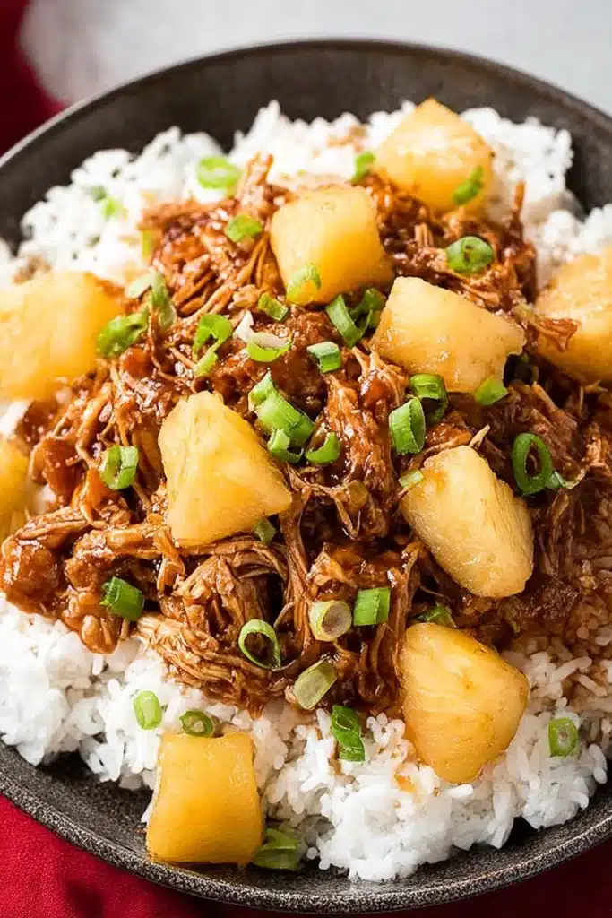 Crockpot Hawaiian BBQ Chicken – Easy, Delicious Slow Cooker 7 Overhead view of Crockpot Hawaiian BBQ Chicken with pineapple and scallions served on white rice