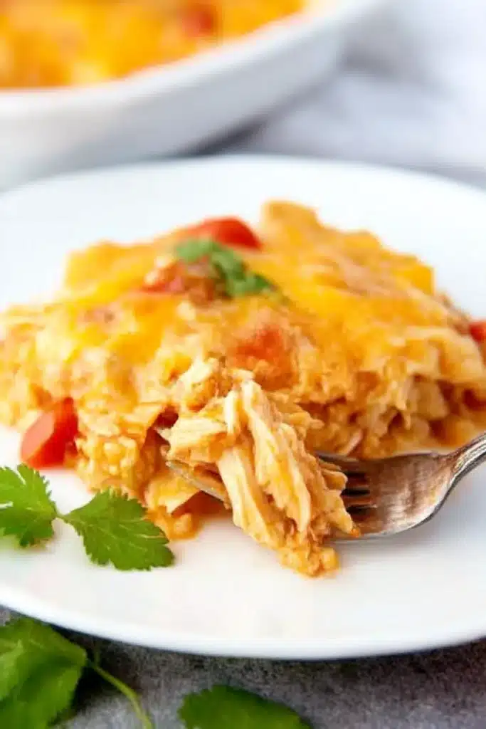 Slow Cooker Chicken Enchilada Casserole – Easy & Delicious 13 Plated slow cooker chicken enchilada casserole with fork and melted cheese