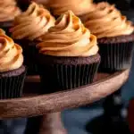 Chocolate Pumpkin Cupcakes | Delicious Cozy Recipe 9 Chocolate Pumpkin Cupcakes arranged on a white table with cozy autumn background