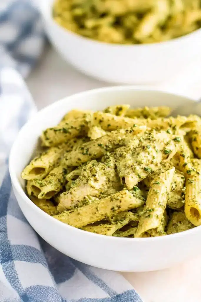 Creamy Chicken Pesto Pasta | Amazing Weeknight Dinner 8 Close-up bowl of creamy chicken pesto pasta with tender chicken and vibrant pesto sauce