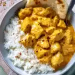 Butter Chicken – Rich, Creamy & Easy to Love 8 Creamy butter chicken served in a white bowl with rice and naan