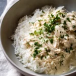 Ranch Chicken Crock Pot – Easy, Creamy & Delicious Dinner 5 Ranch Chicken Crock Pot served over rice in a green bowl with parsley garnish