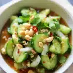 Thai Cucumber Salad – A Quick and Delicious Thai Side Dish 6 Colorful Thai cucumber salad with peanuts, onions, and herbs in sweet chili dressing.
