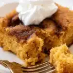 Keto Pumpkin Cake – Easy & Moist Fall Favorite 7 Moist slice of keto pumpkin cake with whipped cream on a plate and fork