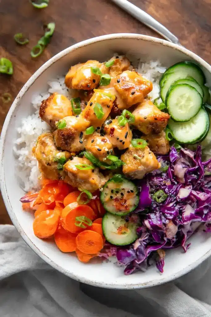 Bang Bang Chicken Bowls | Quick & Easy Dinner Idea 9 Bang Bang Chicken Bowls with crispy chicken, sautéed cabbage and carrots, cucumber slices, rice, green onions, sesame seeds