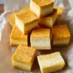 Pumpkin Magic Custard Cake: Easy Recipe with Tips 7 Pumpkin Magic Custard Cake squares showing three distinct layers on parchment paper