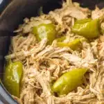 Mississippi Chicken | Easy Tangy Comfort Meal 6 Shredded Mississippi chicken with pepperoncini in a black bowl, tender and juicy