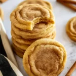 Amazing Pumpkin Snickerdoodle Cookies (Pumpkindoodles) 7 Soft pumpkin snickerdoodle cookies stacked on a stone surface with cinnamon sugar topping