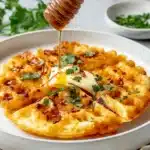 Low Carb Cheese and Egg Waffles – Quick & Crispy Favorite 9 Low carb cheese and egg waffles drizzled with syrup and topped with herbs and butter