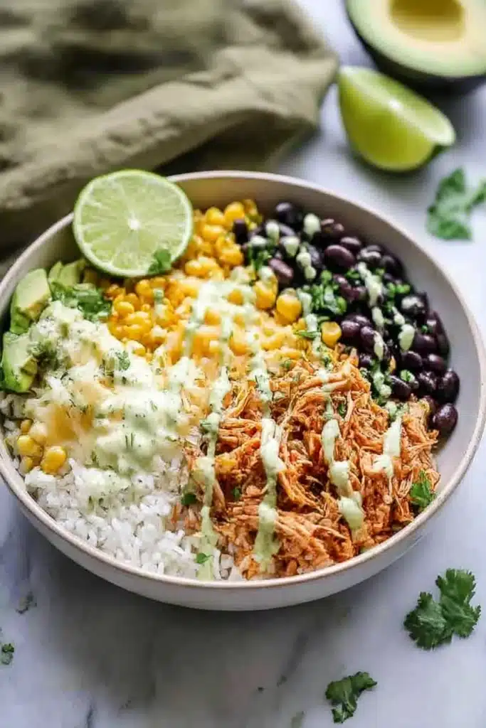 Amazing Slow Cooker Chicken Burrito Bowl Packed with Flavor 7 Slow Cooker Chicken Burrito Bowl with rice, black beans, corn, avocado, cheese, and cilantro-lime dressing