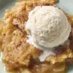 3-Ingredient Apple Dump Cake with vanilla ice cream in a white bowl