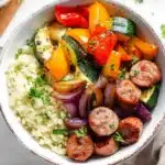 Colorful air fryer chicken sausage and veggies bowl with cauliflower rice