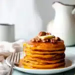 Oatmeal Pumpkin Pancakes – Quick & Cozy Breakfast Treat 8 Oatmeal pumpkin pancakes stacked with butter and syrup, perfect cozy fall breakfast