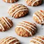 Carrot Cake Cookies: Soft, Sweet & Totally Delicious 18 Vegan carrot cake cookies with white frosting on marble table