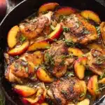 Chicken with Peaches – Quick, Flavorful, Amazing One-Pan 9 Seared chicken with peaches in honey glaze, topped with fresh thyme in a black skillet