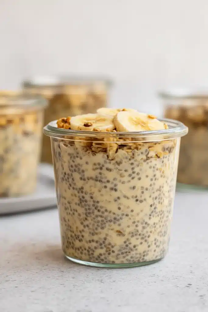  Brown sugar overnight oats in a jar with chia seeds, banana slices, and granola topping
