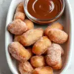 Crispy Air Fryer Churro Bites | Easy Sweet Recipe 6 Crispy air fryer churro bites coated in cinnamon sugar with chocolate dipping sauce in a ceramic dish