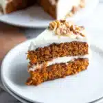 Slice of easy carrot cake with cream cheese frosting on a plate