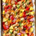Easy Hawaiian Chicken Sheet Pan Meal (Whole30 and Paleo) 6 Colorful Hawaiian chicken sheet pan with pineapple, bell peppers, and red onion on parchment paper.