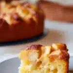 Slice of easy Italian apple cake with caramelized apples on a white plate