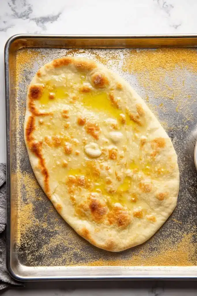 Easy Mediterranean Flatbread Pizza crust baked golden on a tray