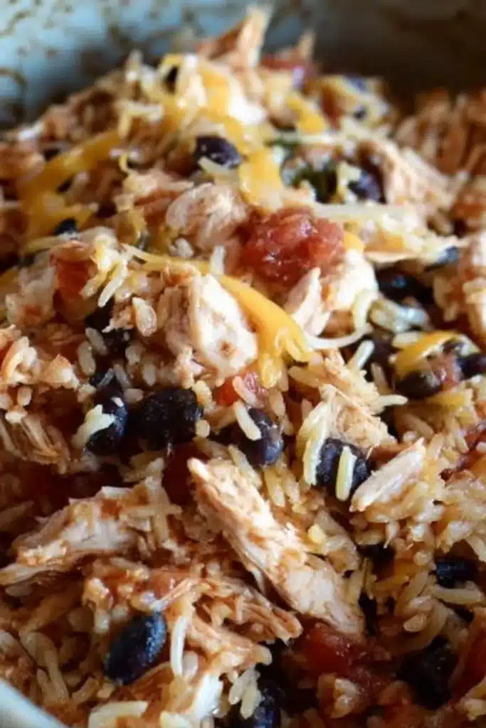 shredded chicken rice stuffed peppers halloween style filling with beans and cheese
