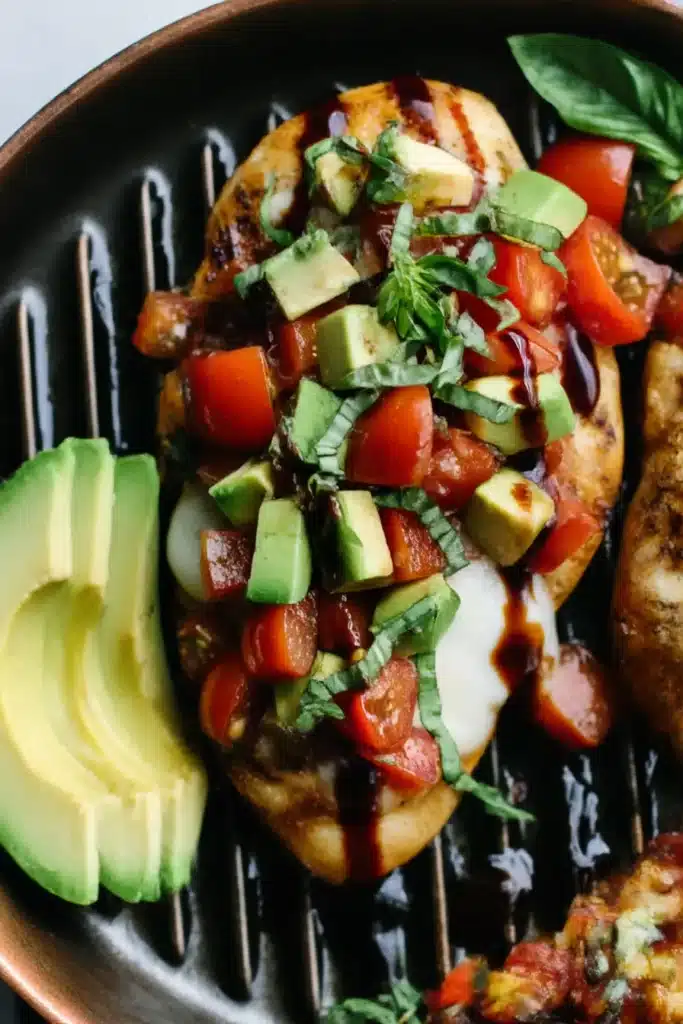Grilled chicken breast topped with avocado, tomato, mozzarella, and balsamic glaze