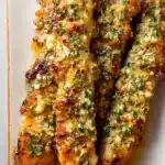 Ranch Garlic Parmesan Chicken Skewers | Bold & Delicious 12 Ranch Garlic Parmesan Chicken Skewers topped with crispy cheese, garlic, and herbs on a white plate
